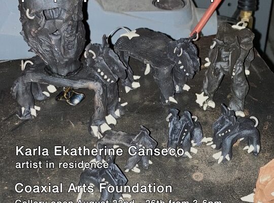 The square image has black outlined white text reading the details of the public events held during Karla’s residency. Creature like brown sculptures sit on a dark table surface as the background image.