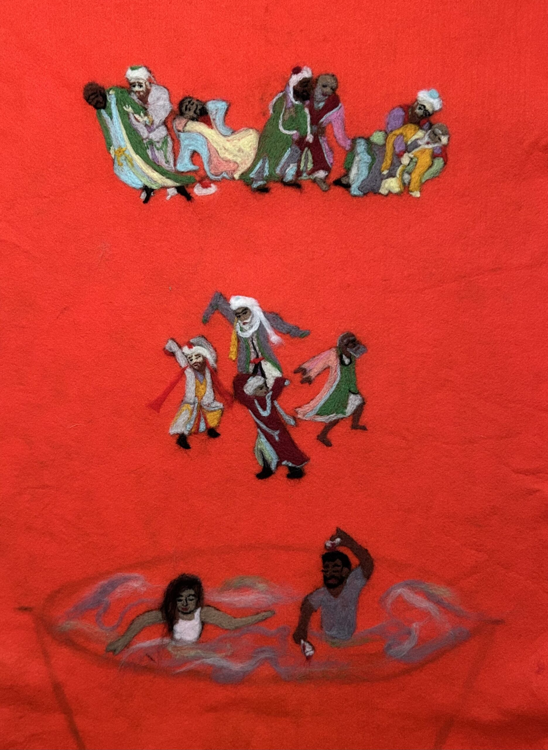 Against a red felt background there are three felted scenes of figures in middle-eastern garb. The bottom scene is two figures in water or air.