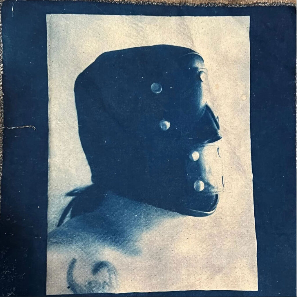 cyanotype of a person in a bondage mask